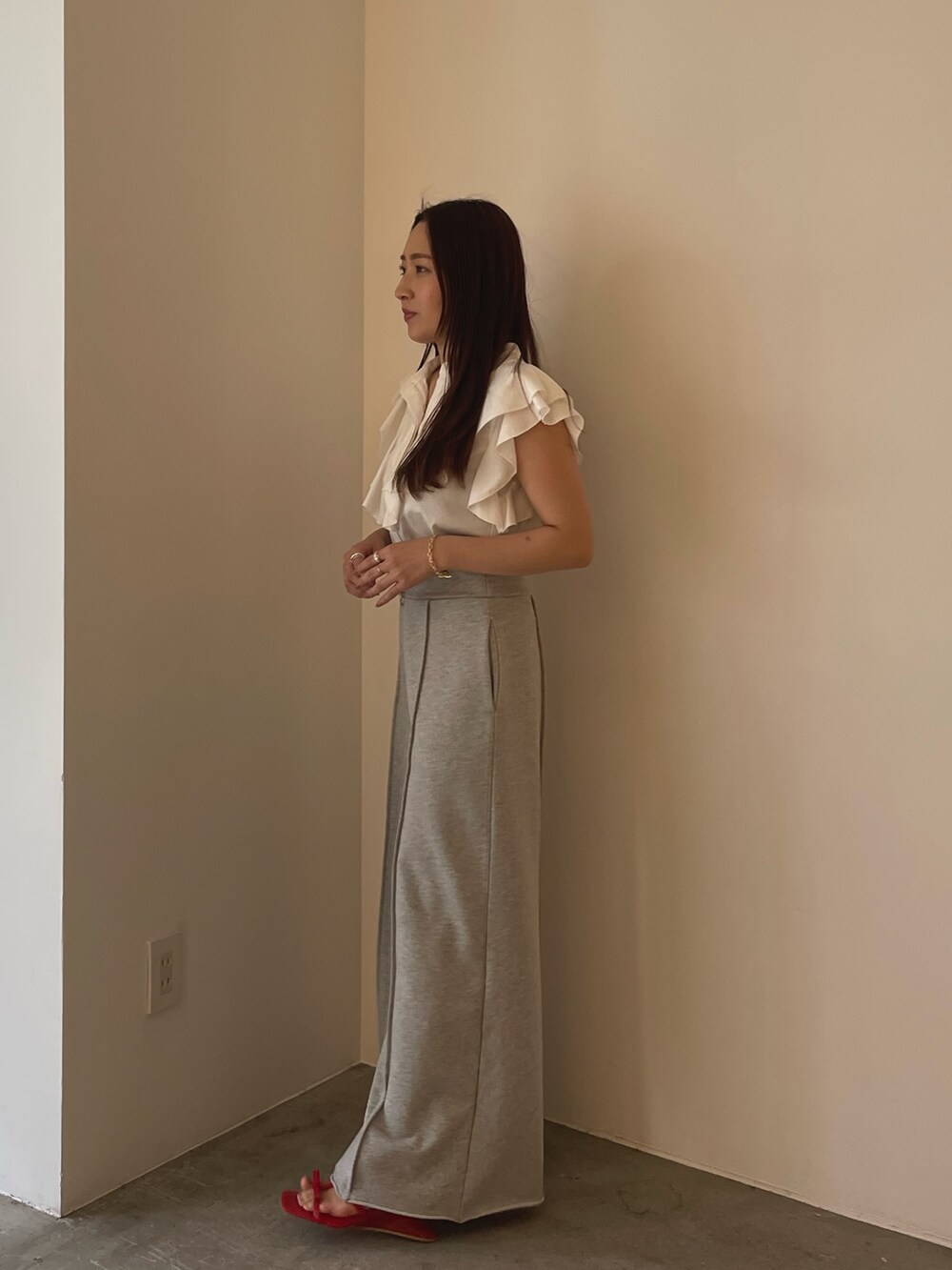 レッド系のサンダル、ホワイト系のシャツ/ブラウス、グレー系のスウェットパンツを着用したレディースの春コーディネートの5枚目の写真