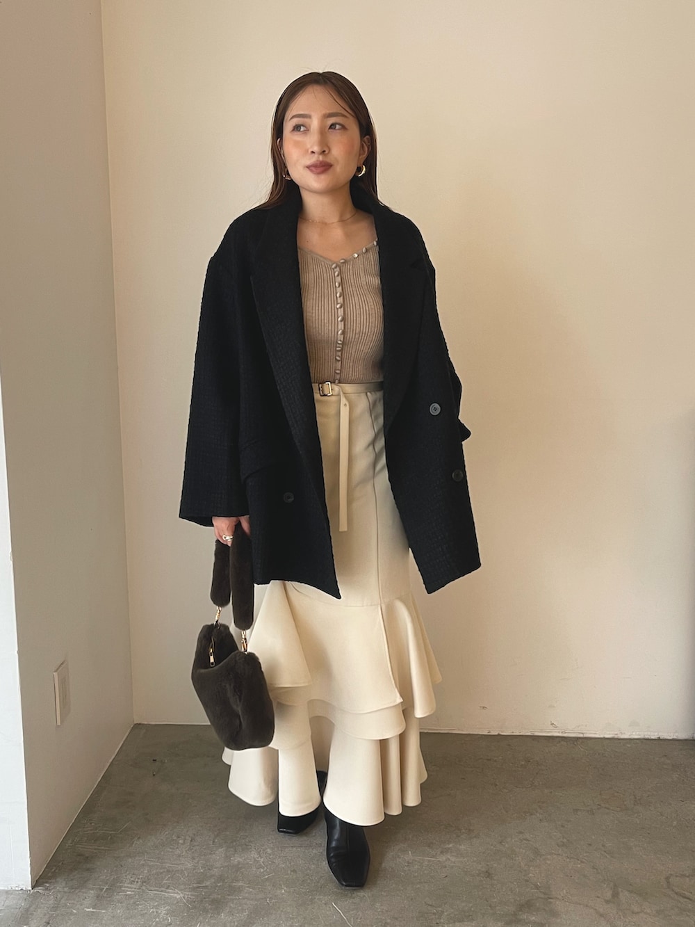 ベージュ系のワンピース、ブラック系のブーツ、ブラウン系のショルダーバッグを着用したレディースの冬コーディネートの4枚目の写真