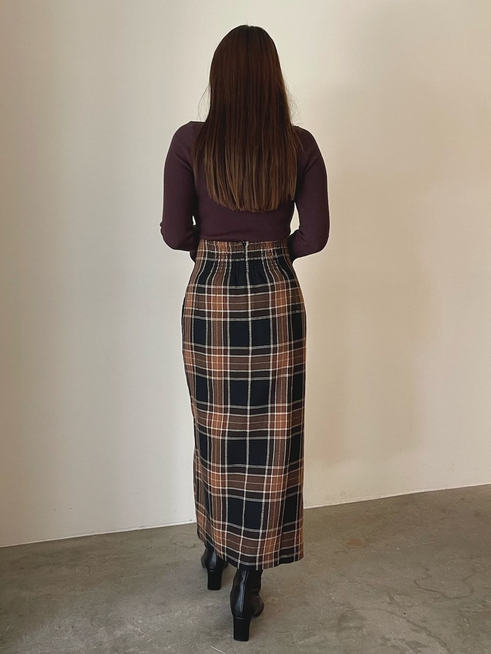 ブラック系のブーツ、ブラウン系のスカート、ブラウン系のニット/セーターを着用したレディースの秋コーディネートの4枚目の写真