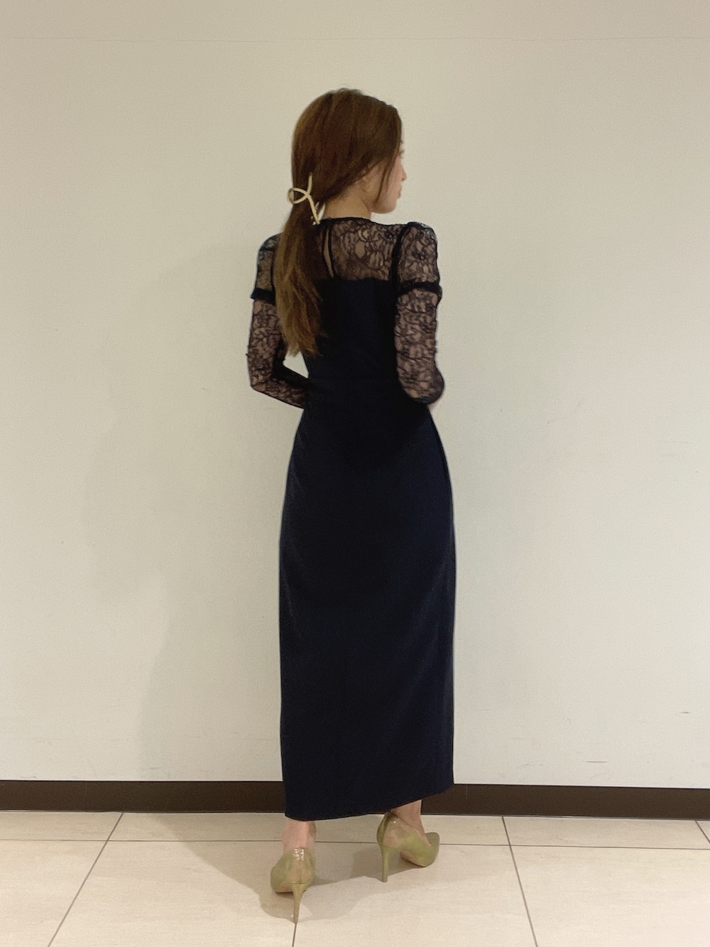 ゴールド系のハンドバッグ、ゴールド系のパンプス、ブルー系のドレスを着用したレディースの夏コーディネートの6枚目の写真