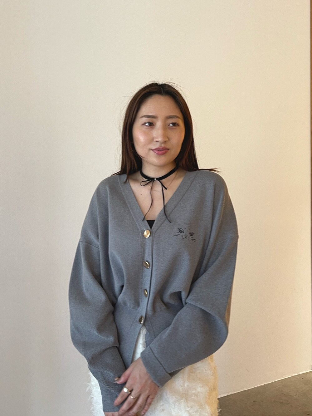 ブラウン系のパンプス、ホワイト系のスカート、グレー系のカーディガン/ボレロを着用したレディースの夏コーディネートの7枚目の写真