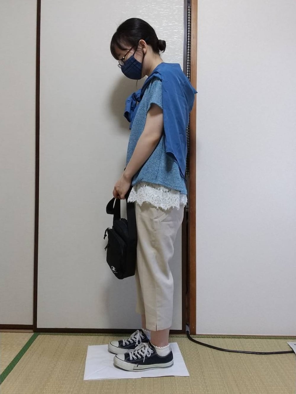 ブルー系のトップスを着用したレディースの秋コーディネートの2枚目の写真