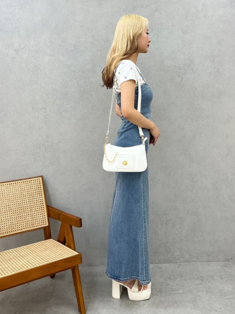 ホワイト系のTシャツ/カットソー、ブルー系のワンピース、ホワイト系のショルダーバッグを着用したレディースの春コーディネートの2枚目の写真