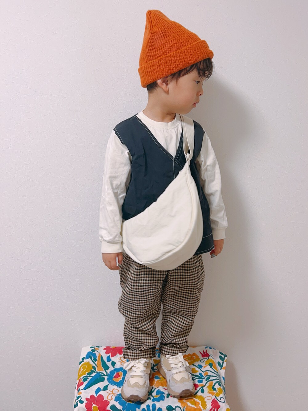 ブラック系のTシャツ/カットソー、ホワイト系のスニーカー、ホワイト系のショルダーバッグを着用したキッズの冬コーディネートの3枚目の写真