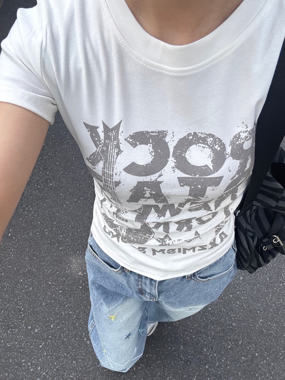 ホワイト系のTシャツ/カットソー、ブルー系のデニムパンツ、ブラック系のバックパック/リュックを着用したレディースの春コーディネートの4枚目の写真