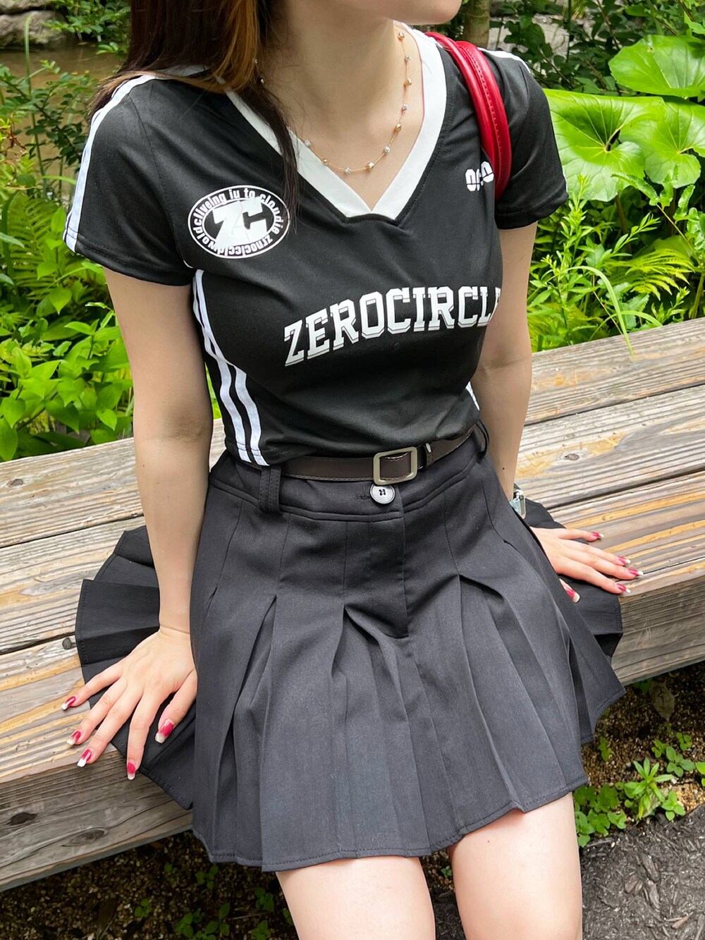 ブラック系のTシャツ/カットソー、レッド系のハンドバッグ、ブラック系のスカートを着用したレディースの夏コーディネートの2枚目の写真