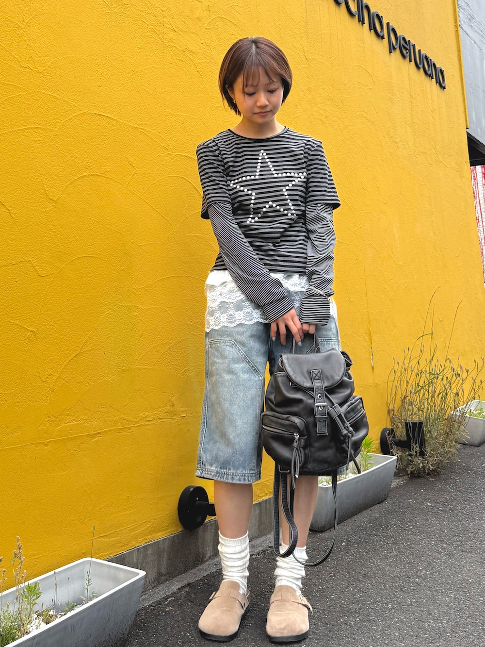 グレー系のTシャツ/カットソー、ブルー系のデニムパンツ、ホワイト系のスカートを着用したレディースの春コーディネートの2枚目の写真