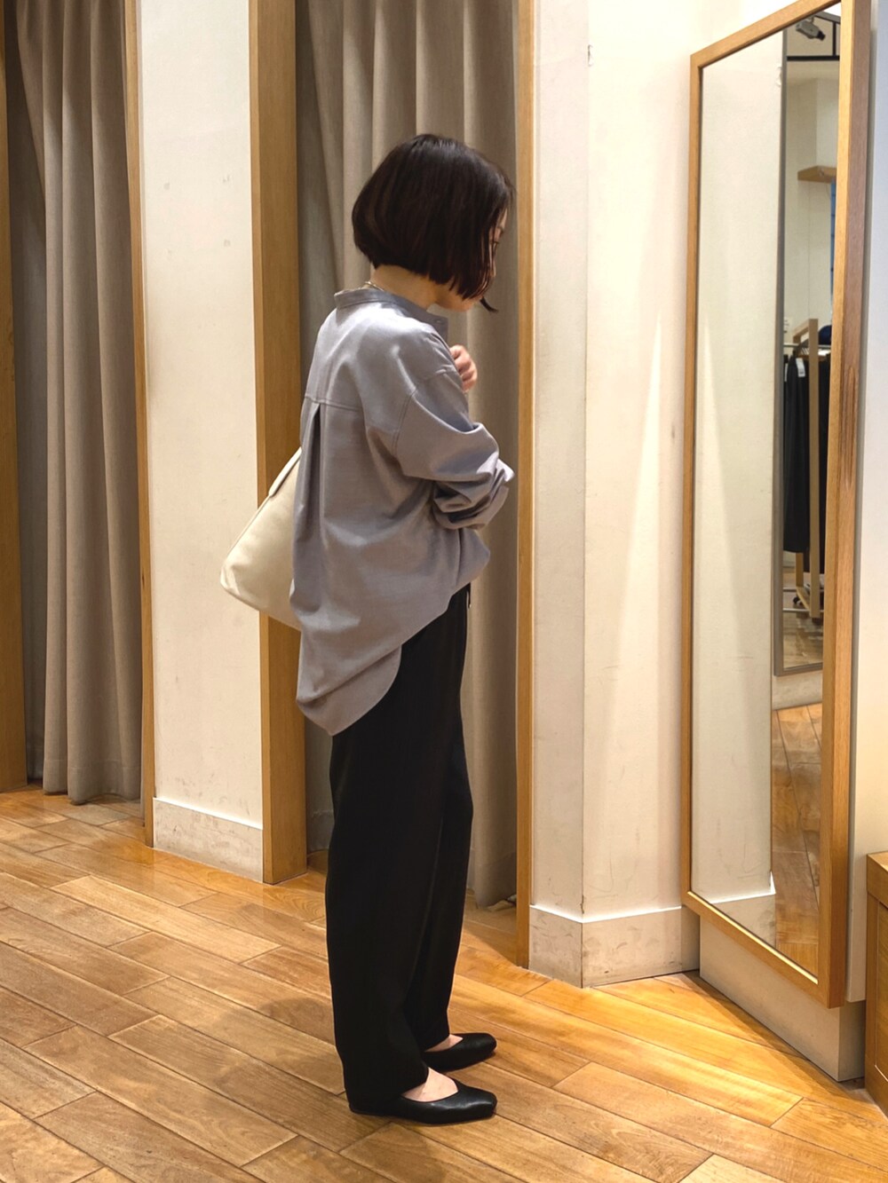 ブラック系のタンクトップ、ブラック系のその他パンツ、ホワイト系のショルダーバッグを着用したレディースの春コーディネートの3枚目の写真