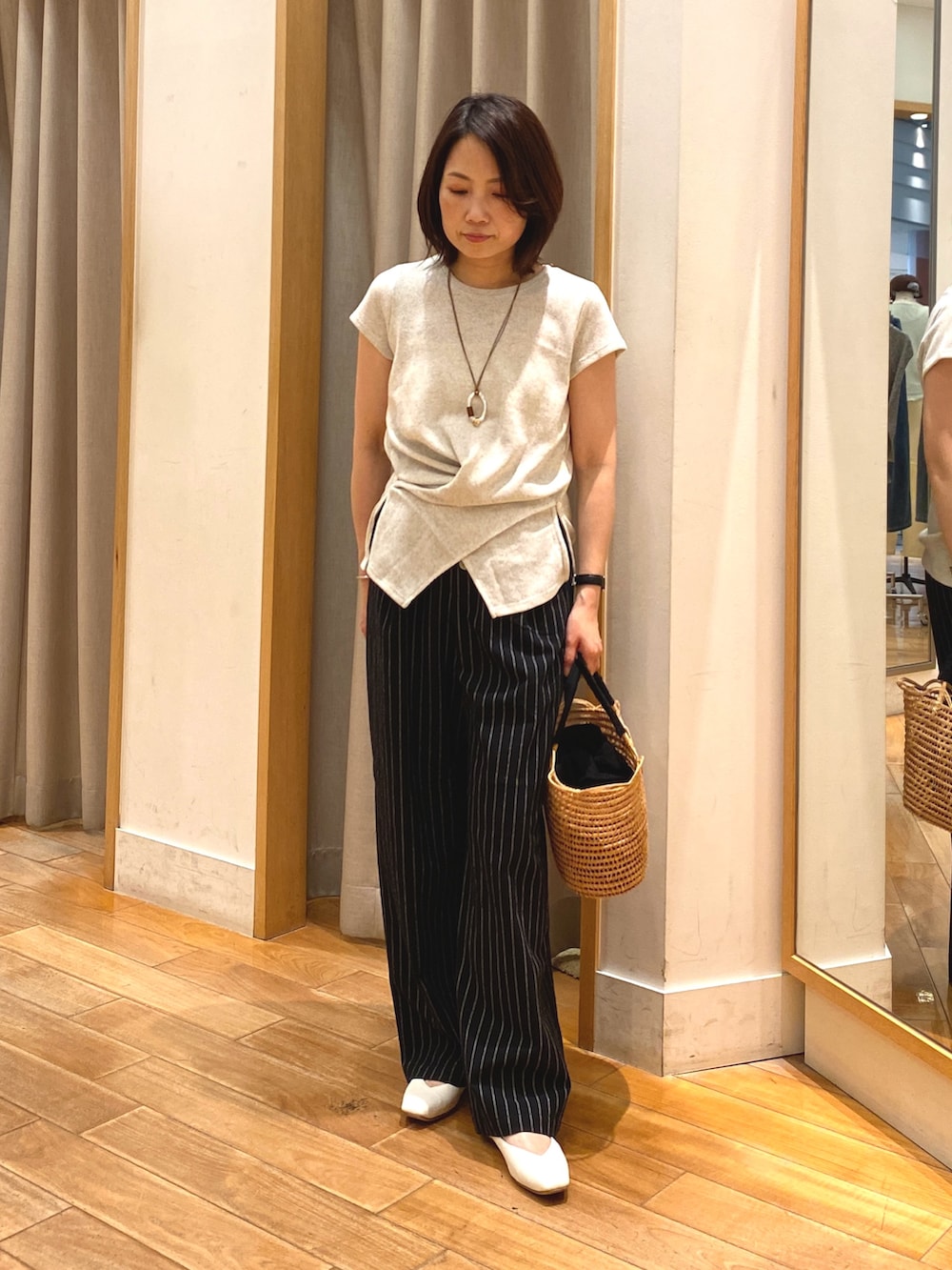 ホワイト系のTシャツ/カットソー、ブラック系のかごバッグ、ブラック系のその他パンツを着用したレディースの夏コーディネートの3枚目の写真