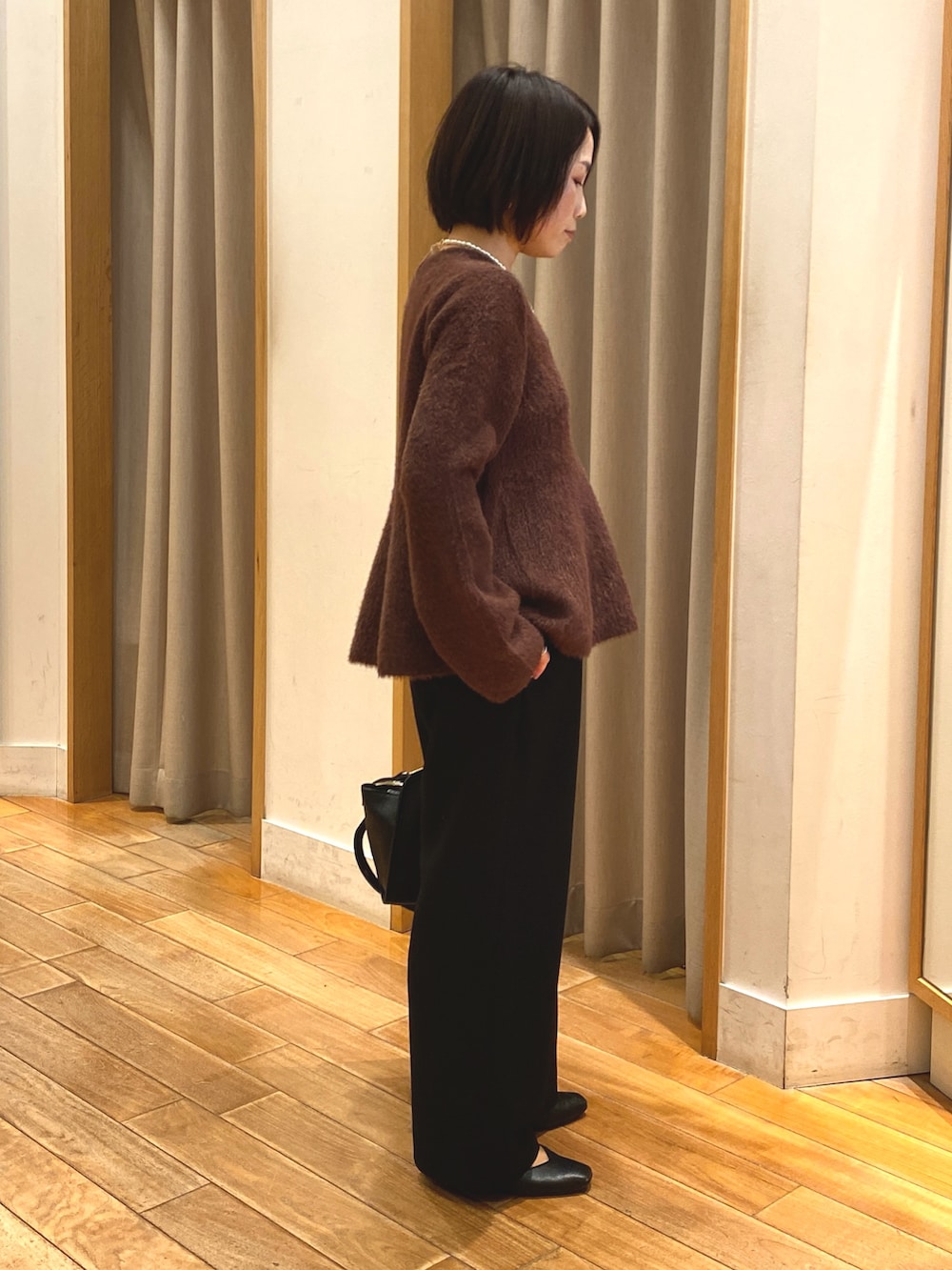 ブラック系のその他パンツ、ブラック系のショルダーバッグ、ブラウン系のニット/セーターを着用したレディースの冬コーディネートの5枚目の写真
