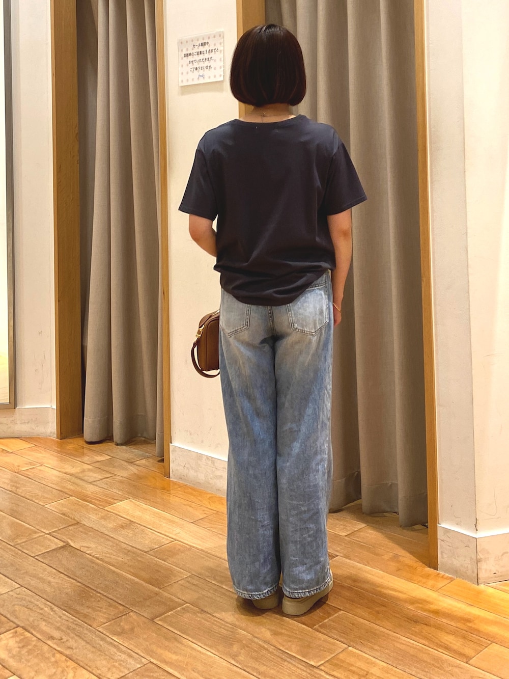 イエロー系のショルダーバッグ、ブルー系のデニムパンツ、グレー系のTシャツ/カットソーを着用したレディースの夏コーディネートの6枚目の写真