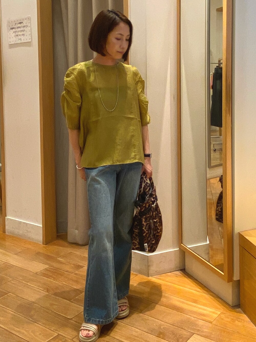 ブルー系のデニムパンツ、イエロー系のシャツ/ブラウスを着用したレディースの夏コーディネートの2枚目の写真