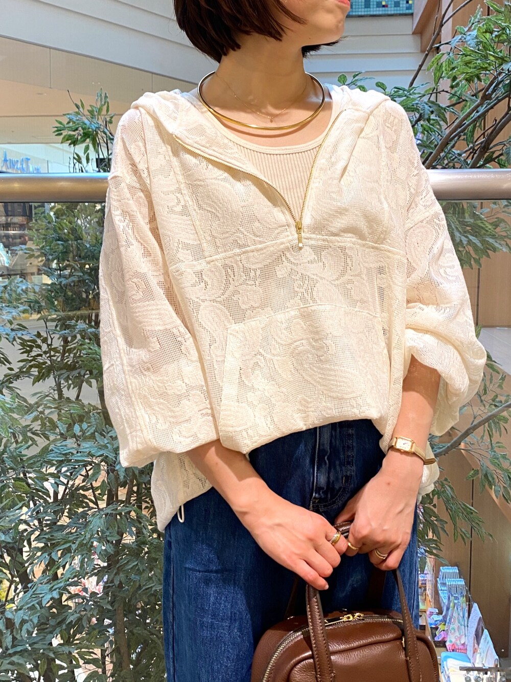 ホワイト系のシャツ/ブラウス、ブルー系のデニムパンツ、ブラウン系のボストンバッグを着用したレディースの秋コーディネートの2枚目の写真