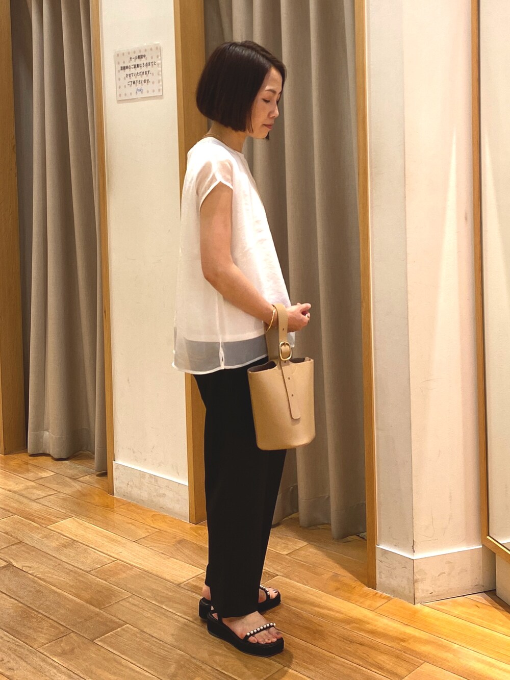 ブラック系のその他パンツ、ホワイト系のシャツ/ブラウス、ベージュ系のショルダーバッグを着用したレディースの夏コーディネートの6枚目の写真