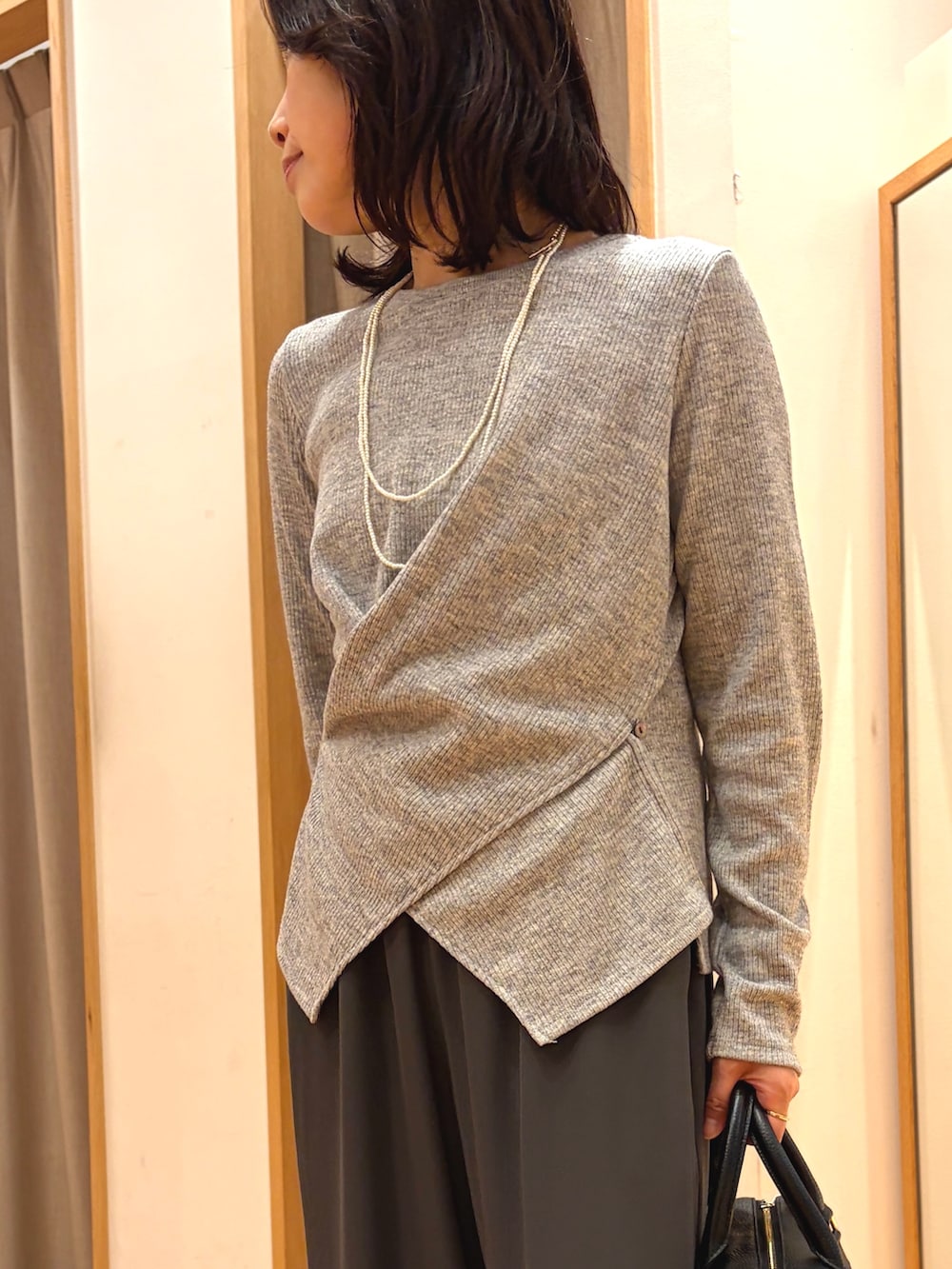 グレー系のTシャツ/カットソー、グレー系のその他パンツ、ブラック系のボストンバッグを着用したレディースの秋コーディネートの3枚目の写真