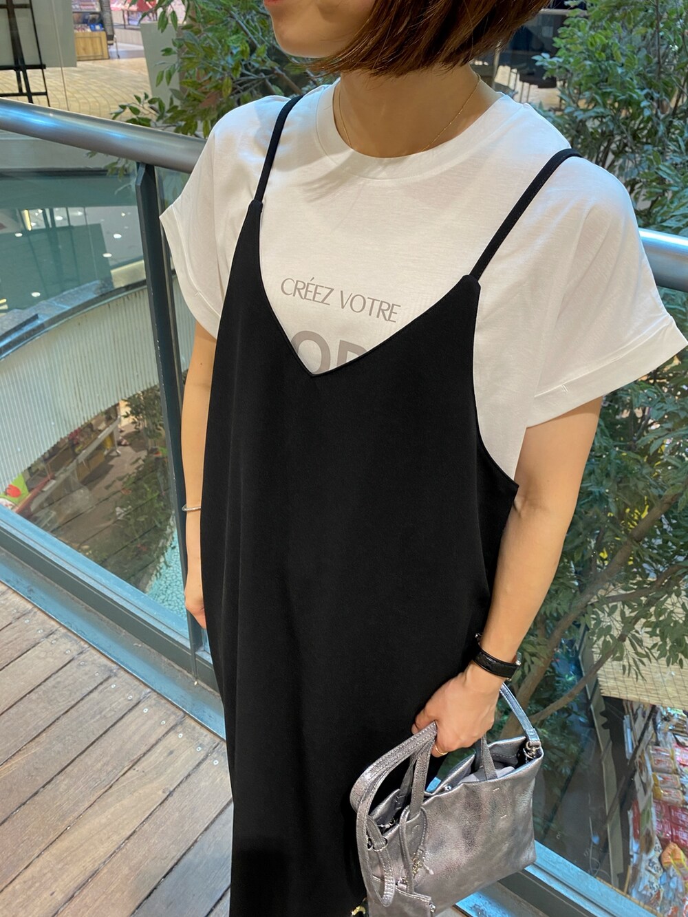ブラック系のワンピース、シルバー系のショルダーバッグ、ホワイト系のTシャツ/カットソーを着用したレディースの夏コーディネートの7枚目の写真