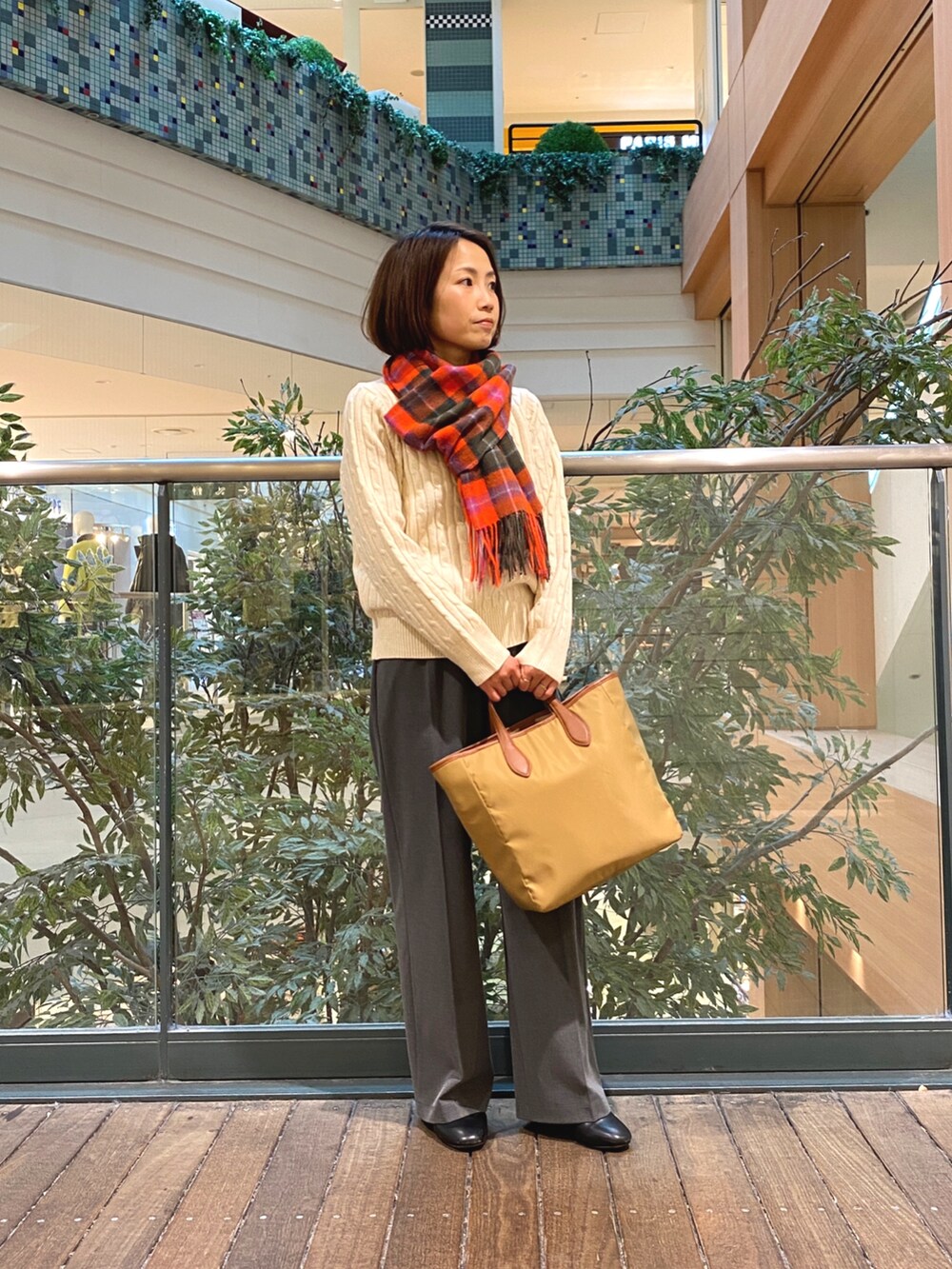 ホワイト系のニット/セーター、グレー系のその他パンツ、イエロー系のショルダーバッグを着用したレディースの秋コーディネートの2枚目の写真