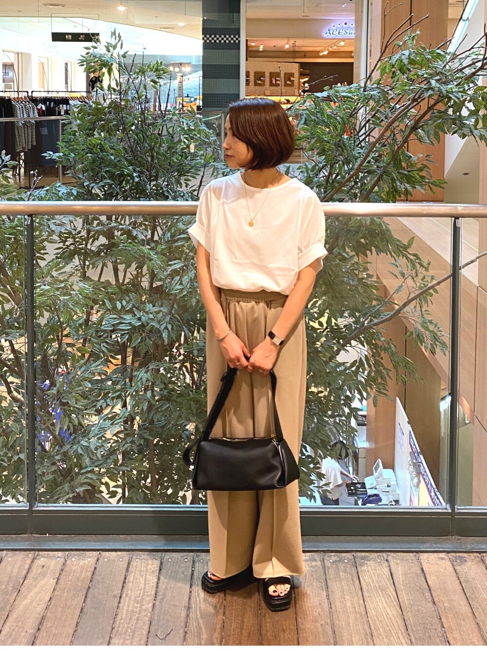 ホワイト系のTシャツ/カットソー、ブラック系のその他パンツ、ブラック系のショルダーバッグを着用したレディースの夏コーディネートの2枚目の写真