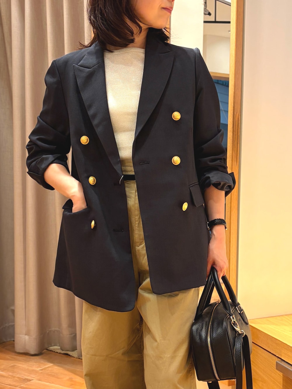 ベージュ系のその他パンツ、ブルー系のテーラードジャケット、ホワイト系のTシャツ/カットソーを着用したレディースの秋コーディネートの3枚目の写真