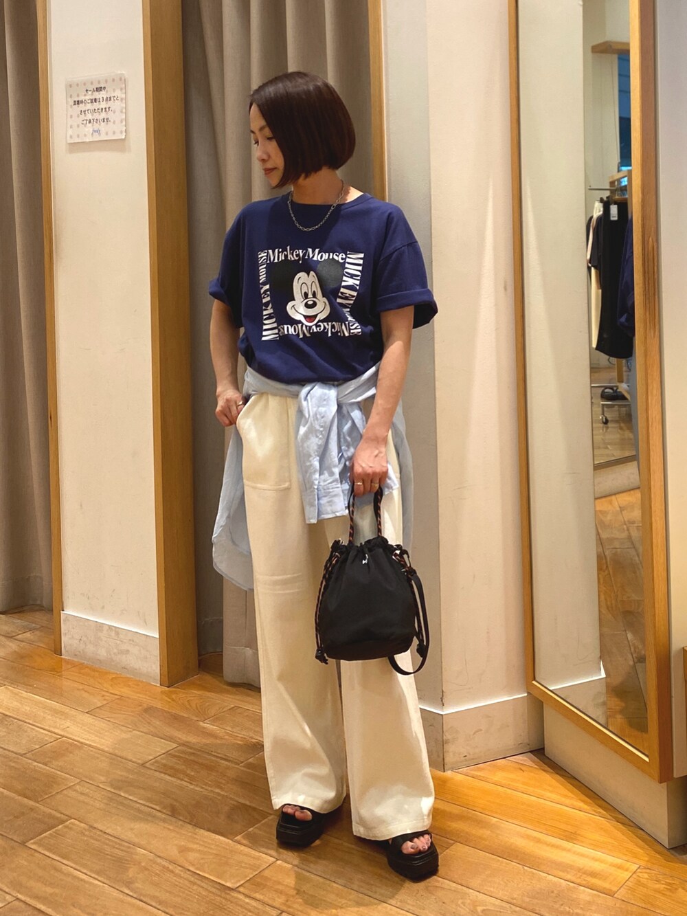 ブルー系のTシャツ/カットソー、ホワイト系のデニムパンツ、ブラック系のショルダーバッグを着用したレディースの夏コーディネートの2枚目の写真