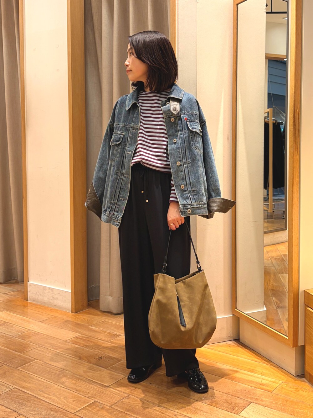 ブラック系のその他パンツ、ブルー系のデニムジャケット、ブルー系のTシャツ/カットソーを着用したレディースの秋コーディネートの8枚目の写真