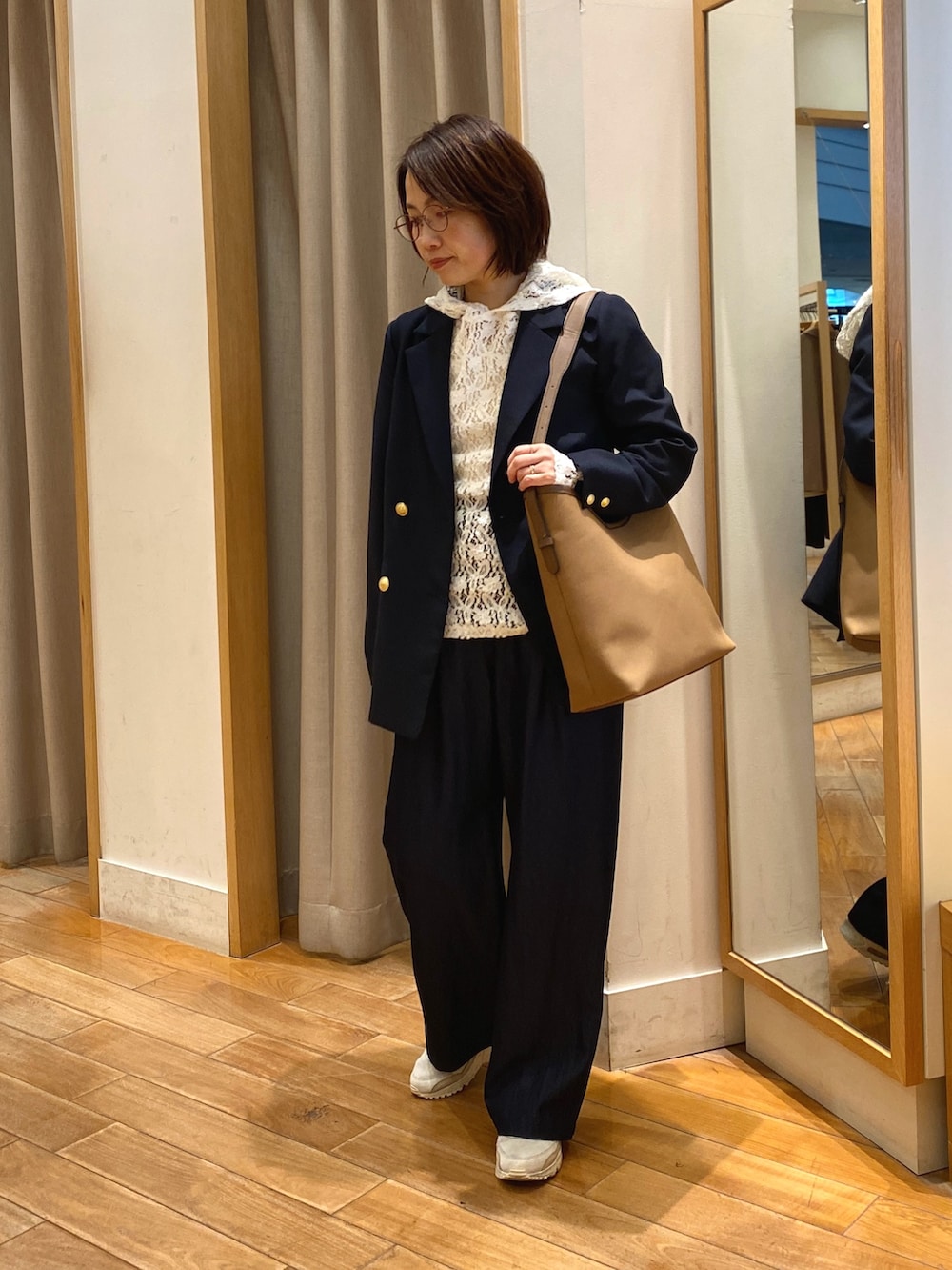 ブラウン系のショルダーバッグ、ホワイト系のTシャツ/カットソー、ブルー系のテーラードジャケットを着用したレディースの春コーディネートの3枚目の写真