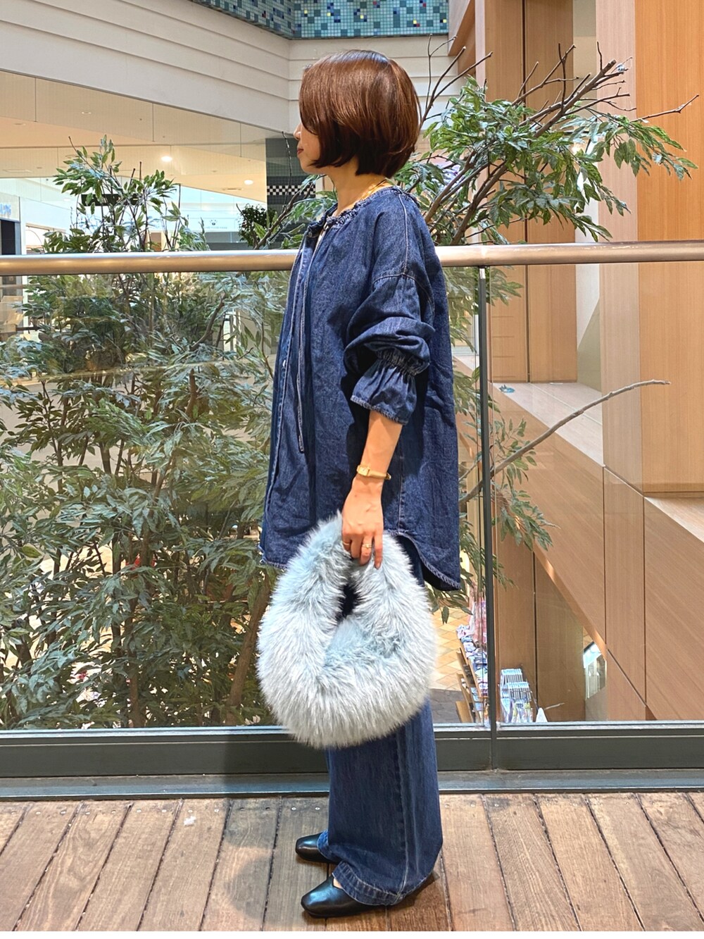 ブルー系のシャツ/ブラウス、ブルー系のデニムパンツ、ホワイト系のTシャツ/カットソーを着用したレディースの秋コーディネートの5枚目の写真