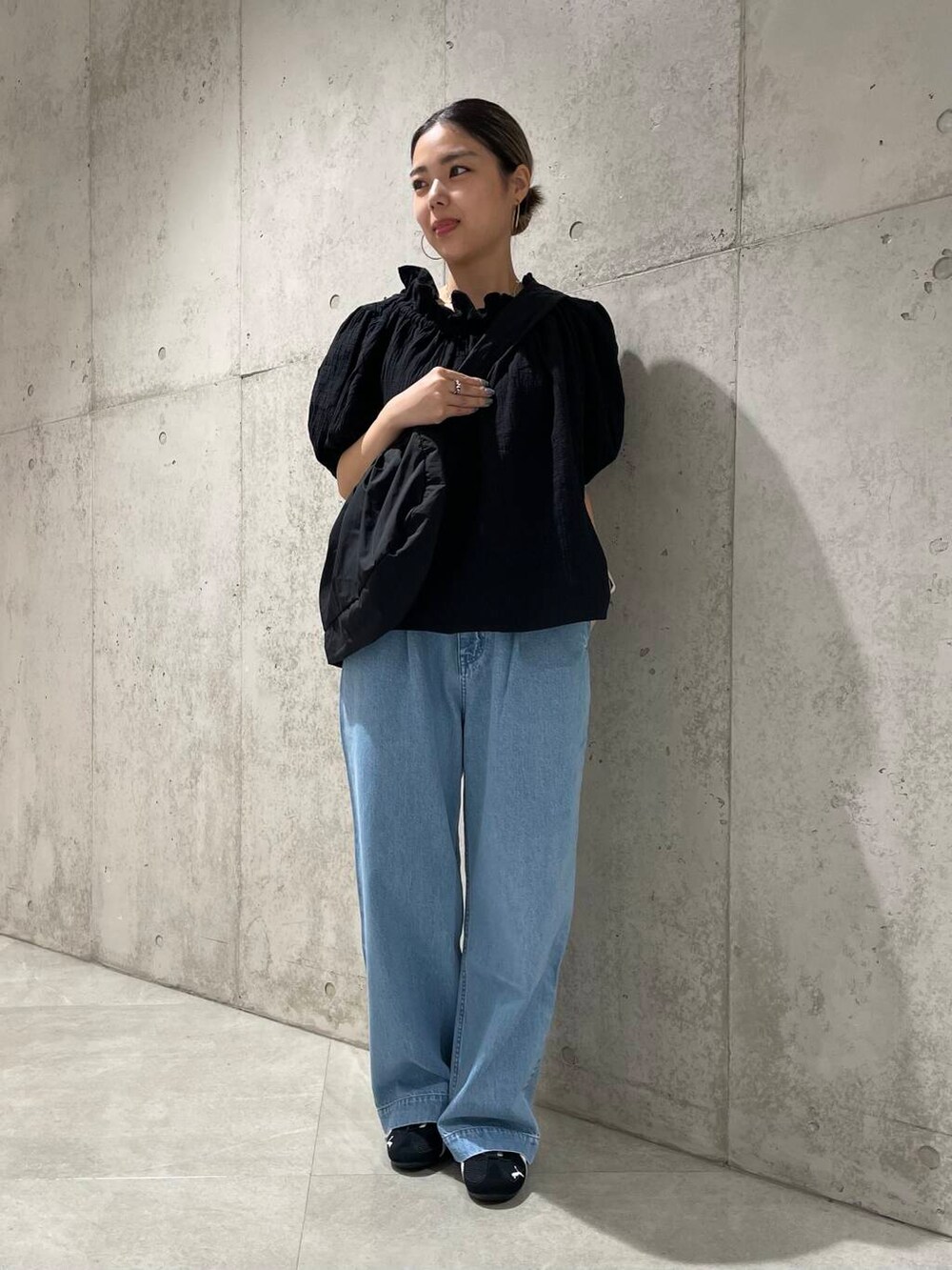 ブルー系のデニムパンツ、ブラック系のショルダーバッグ、ブラック系のシャツ/ブラウスを着用したレディースの夏コーディネートの4枚目の写真