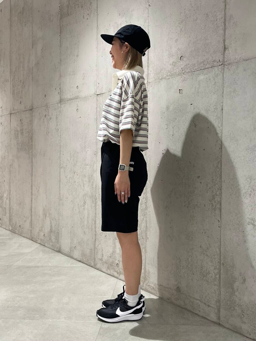 ブラック系のスニーカー、ブラック系のその他パンツ、ホワイト系のTシャツ/カットソーを着用したレディースの春コーディネートの2枚目の写真