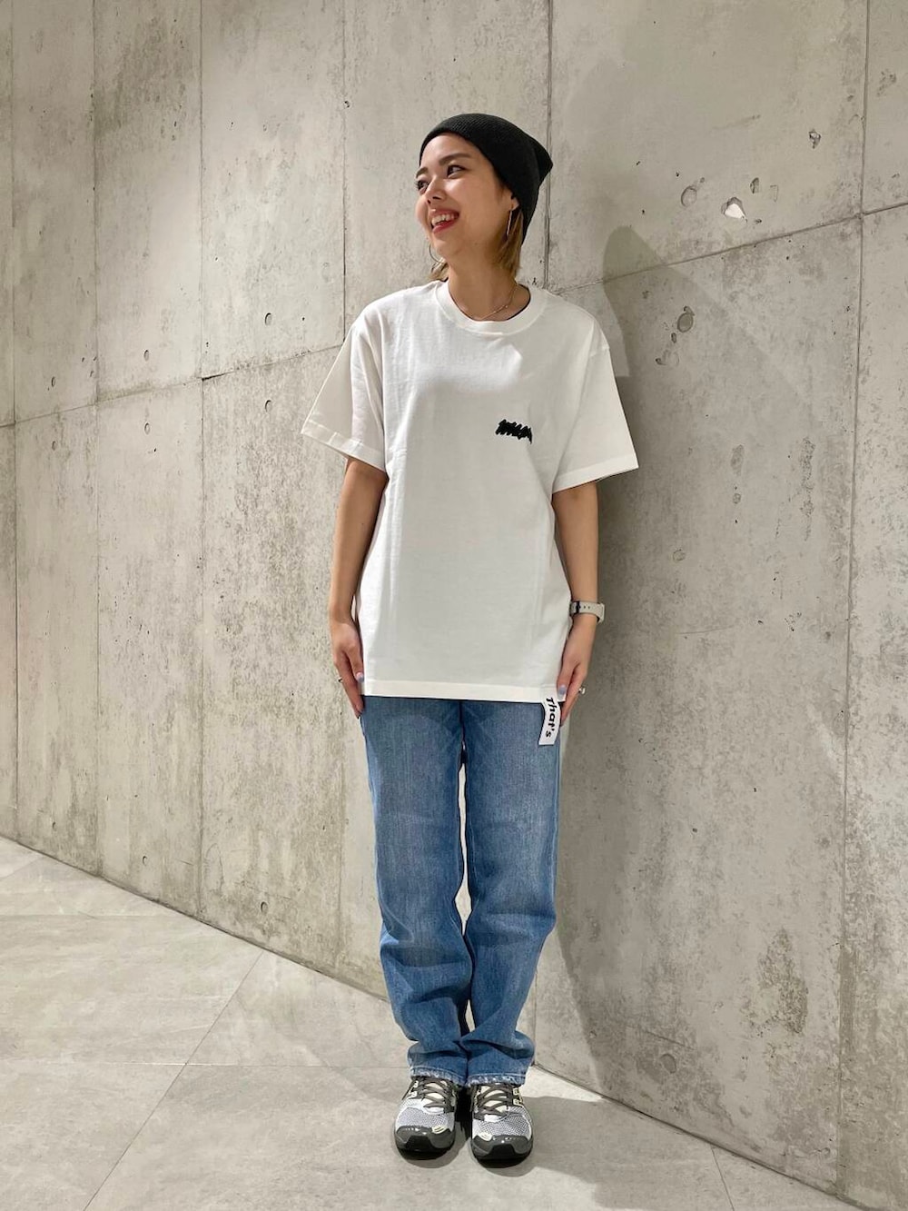 ブルー系のデニムパンツ、ブラック系のタンクトップ、ベージュ系のショルダーバッグを着用したレディースの春コーディネートの7枚目の写真