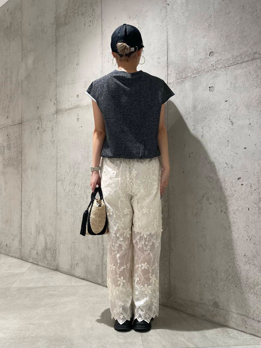 ブラック系のかごバッグ、ブラック系のTシャツ/カットソー、ホワイト系のその他パンツを着用したレディースの夏コーディネートの4枚目の写真