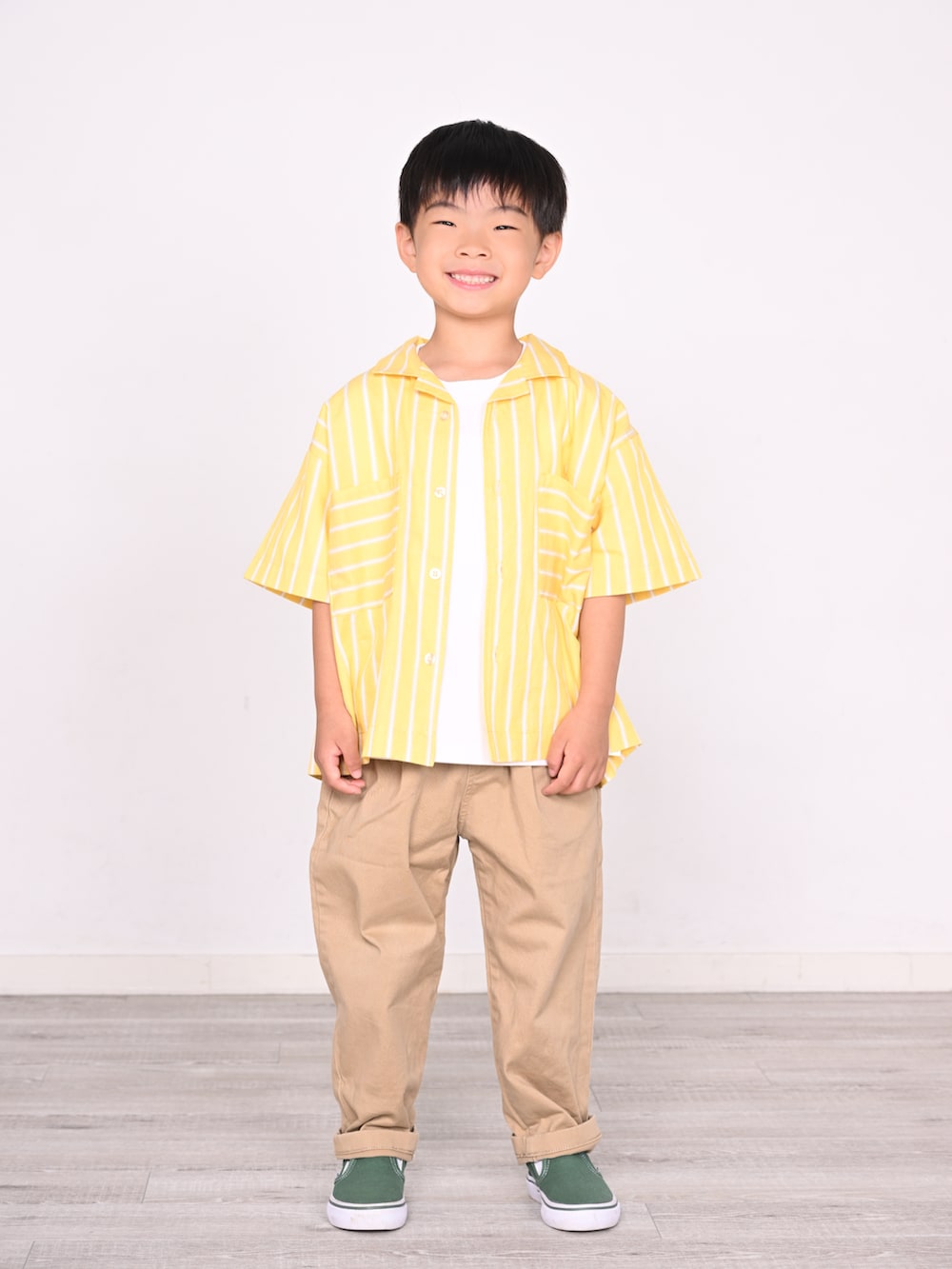 イエロー系のシャツ/ブラウス、グリーン系のスリッポン、ホワイト系のTシャツ/カットソーを着用したキッズの夏コーディネートの2枚目の写真