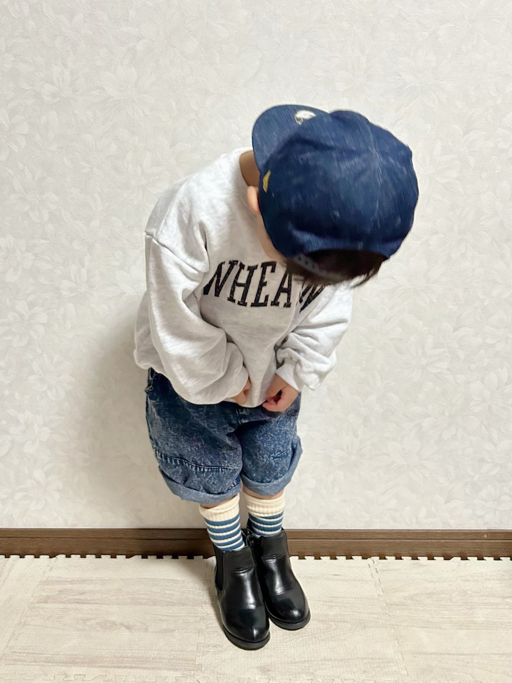 グレー系のスウェット、ブルー系のデニムパンツ、ブラック系のブーツを着用したキッズの秋コーディネートの4枚目の写真