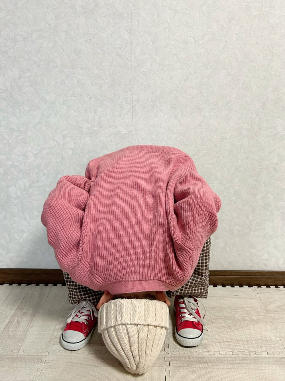 ホワイト系のニット/セーター、ピンク系のカーディガン/ボレロ、ブラウン系のパンツを着用したキッズの冬コーディネートの5枚目の写真