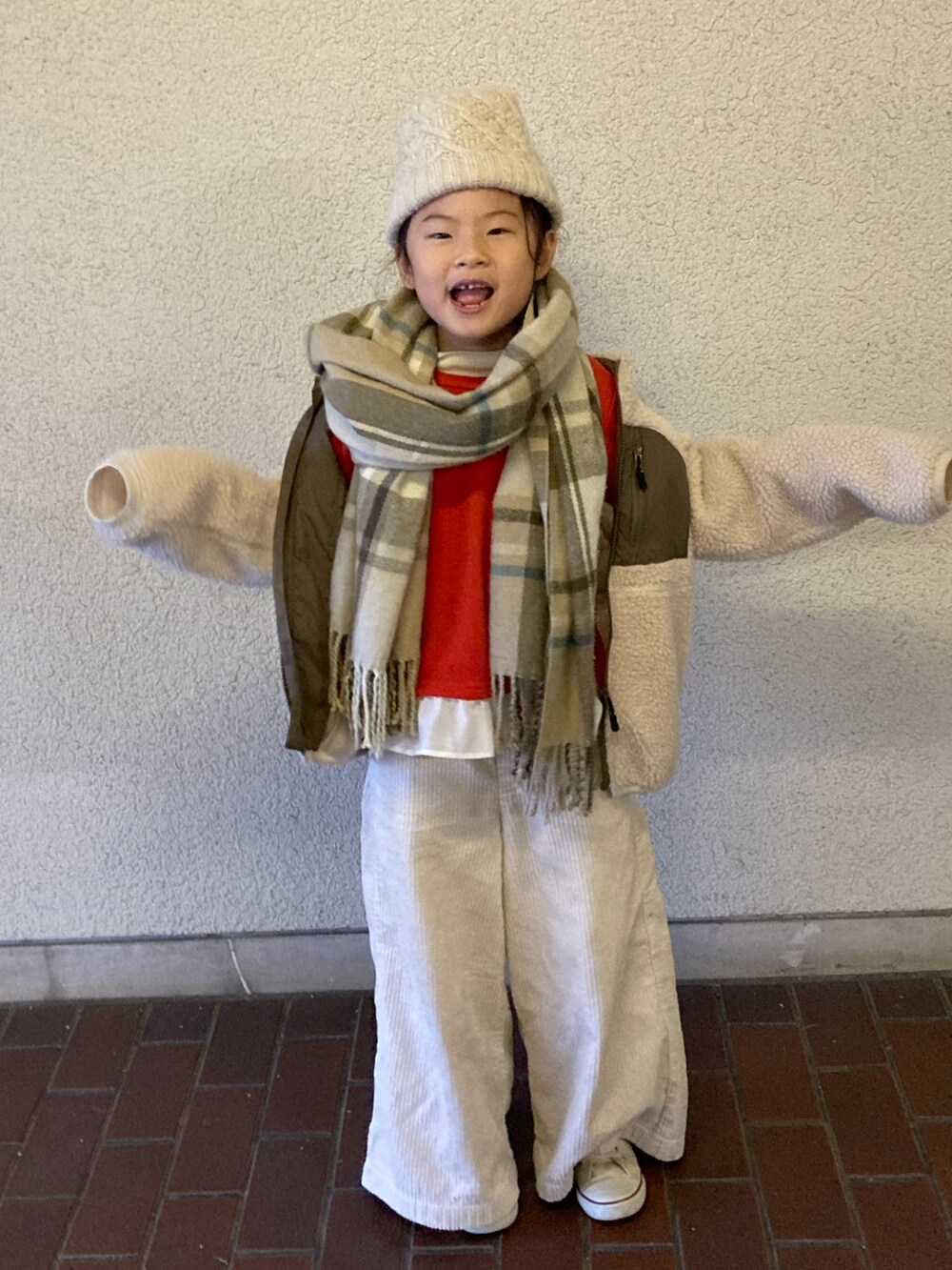 レッド系のスウェット、ベージュ系のその他パンツ、ホワイト系のTシャツ/カットソーを着用したキッズの冬コーディネートの2枚目の写真