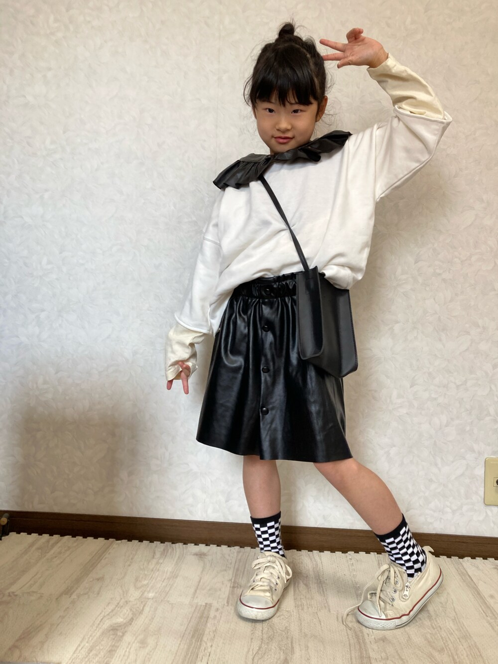 ホワイト系のTシャツ/カットソー、ホワイト系のスウェット、ブラック系のスカートを着用したキッズの冬コーディネートの4枚目の写真