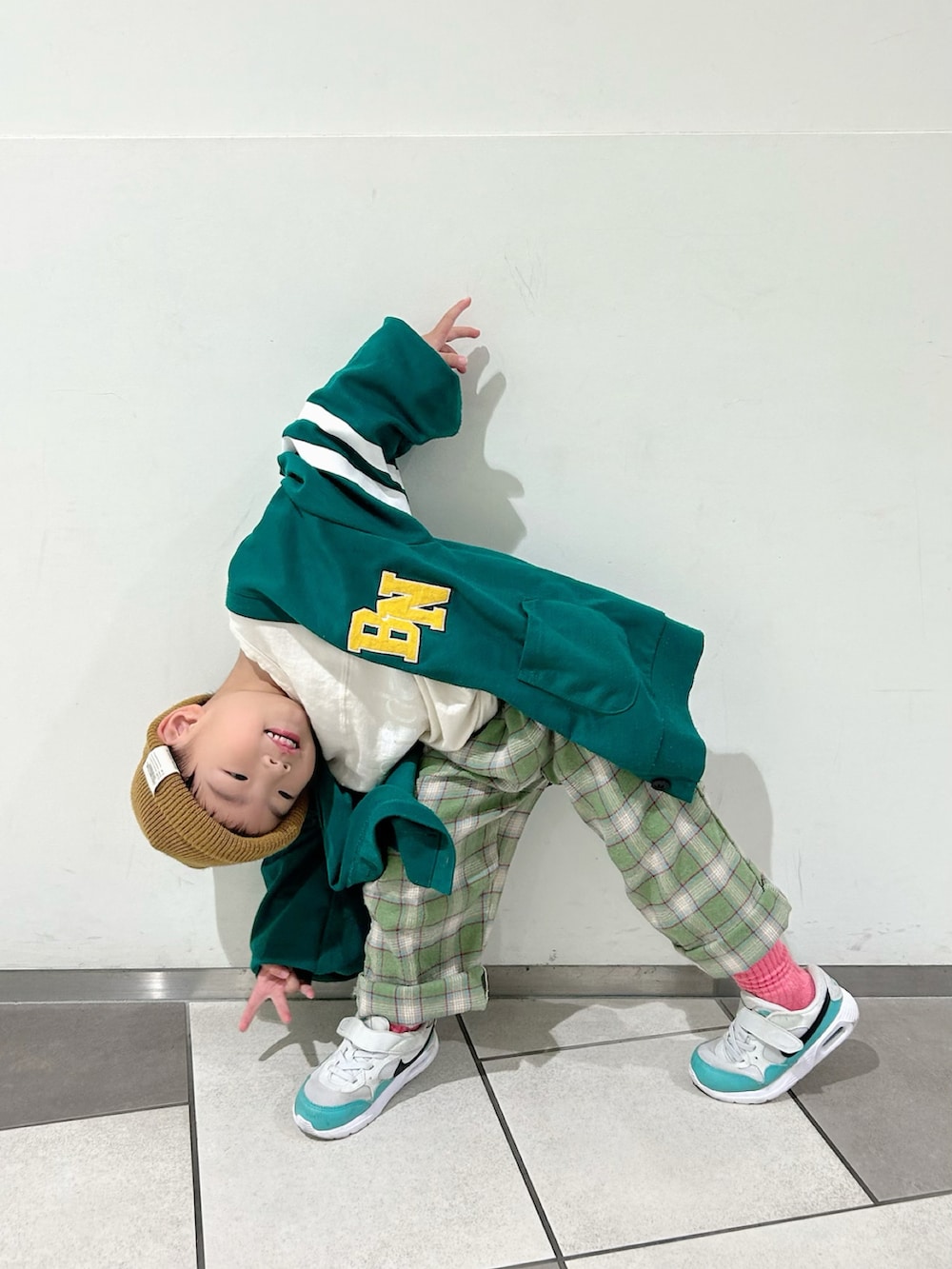 ホワイト系のTシャツ/カットソー、グリーン系のスラックス、グリーン系のカーディガン/ボレロを着用したキッズの秋コーディネートの2枚目の写真