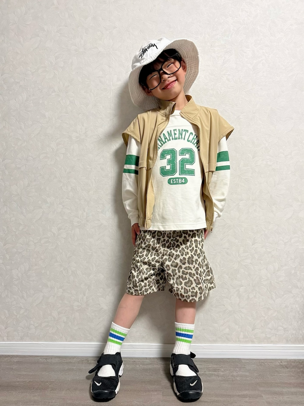 ベージュ系のその他パンツ、ホワイト系のショルダーバッグ、ブラック系のスニーカーを着用したキッズの春コーディネートの3枚目の写真