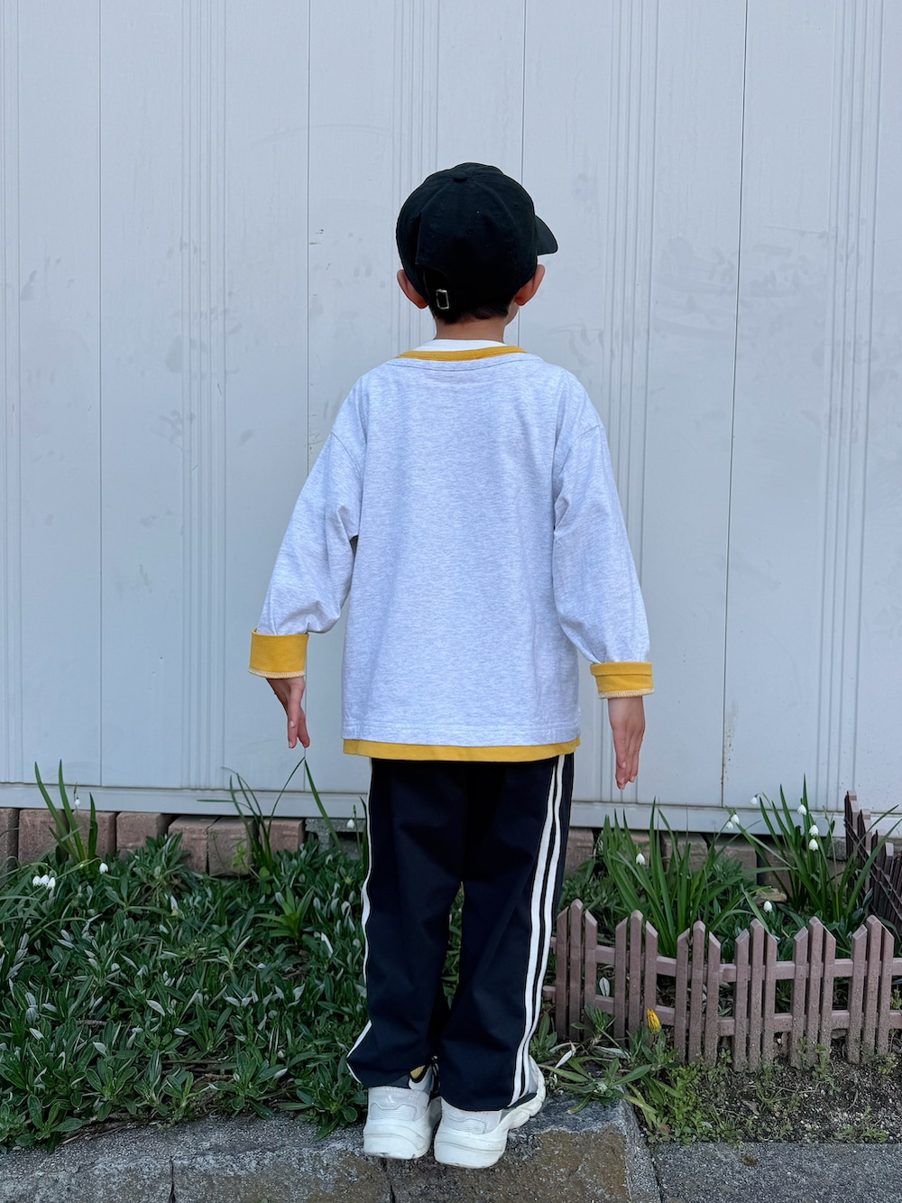 イエロー系のTシャツ/カットソー、ブラック系のその他パンツ、ホワイト系のスニーカーを着用したキッズの春コーディネートの5枚目の写真