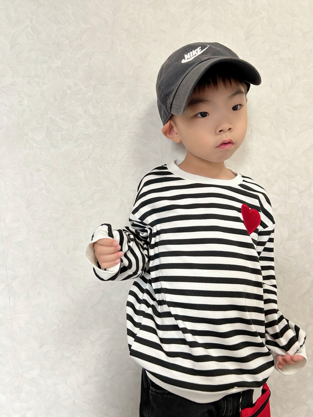 ホワイト系のTシャツ/カットソー、グレー系のデニムパンツ、ブラック系のスニーカーを着用したキッズの秋コーディネートの5枚目の写真