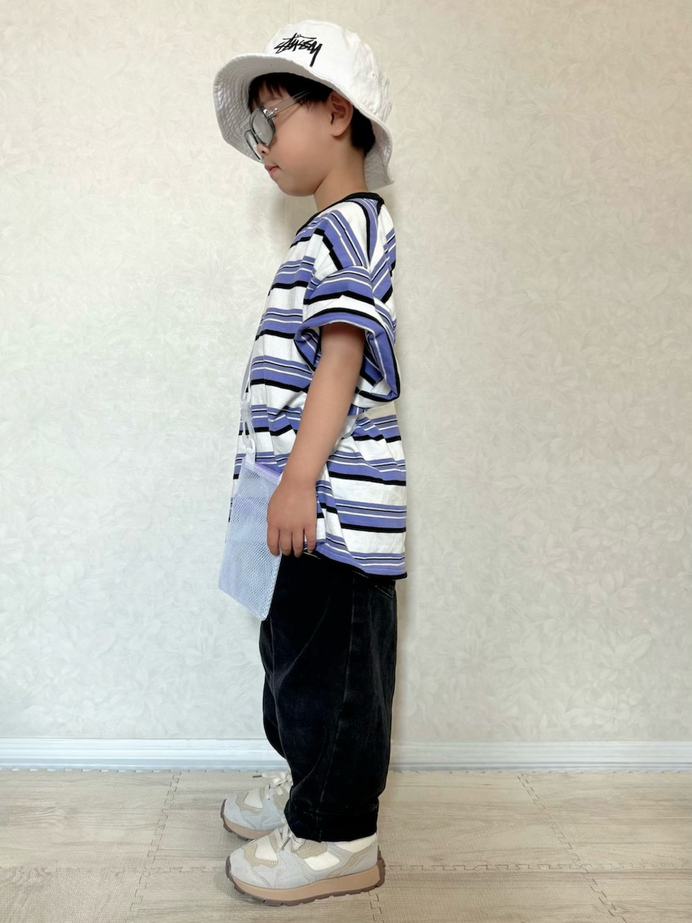 パープル系のTシャツ/カットソー、グレー系のデニムパンツ、ホワイト系のショルダーバッグを着用したキッズの夏コーディネートの2枚目の写真