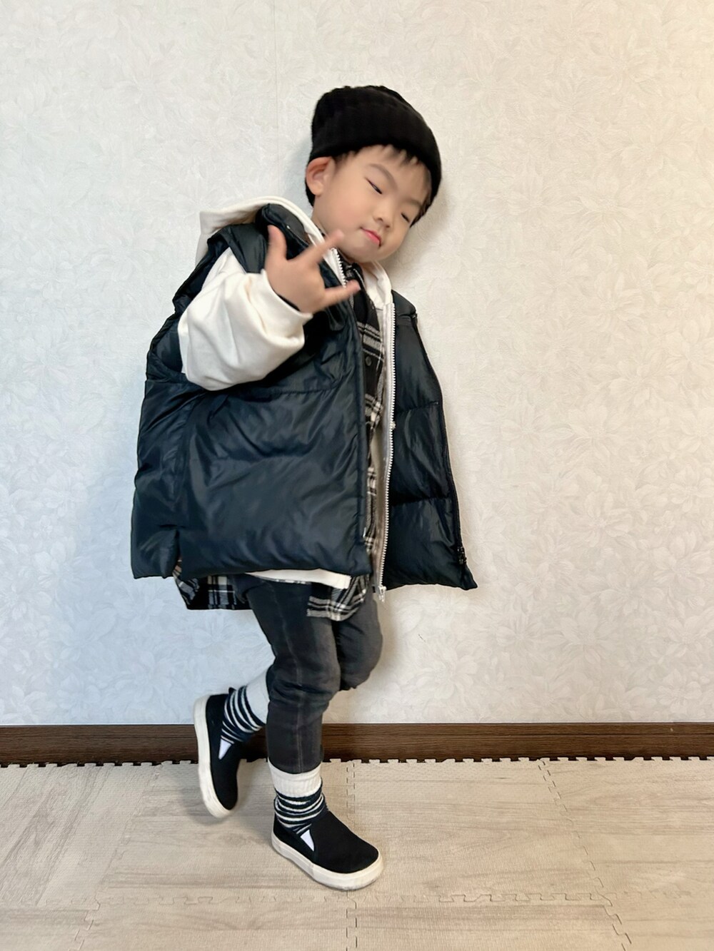 ブラック系のシャツ/ブラウス、ホワイト系のパーカー、ブラック系のダウンベストを着用したキッズの秋コーディネートの3枚目の写真