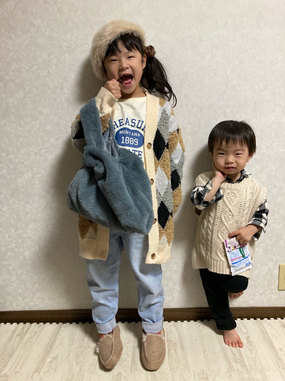 ベージュ系のカーディガン/ボレロ、ホワイト系のTシャツ/カットソー、ブルー系のデニムパンツを着用したキッズの冬コーディネートの2枚目の写真