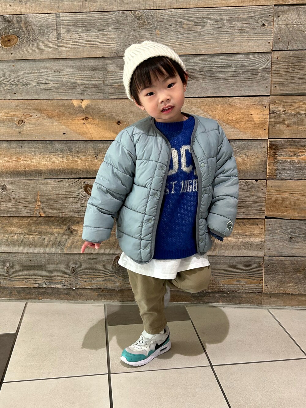 ブルー系のニット/セーター、ベージュ系のその他パンツ、ホワイト系のスニーカーを着用したキッズの冬コーディネートの4枚目の写真