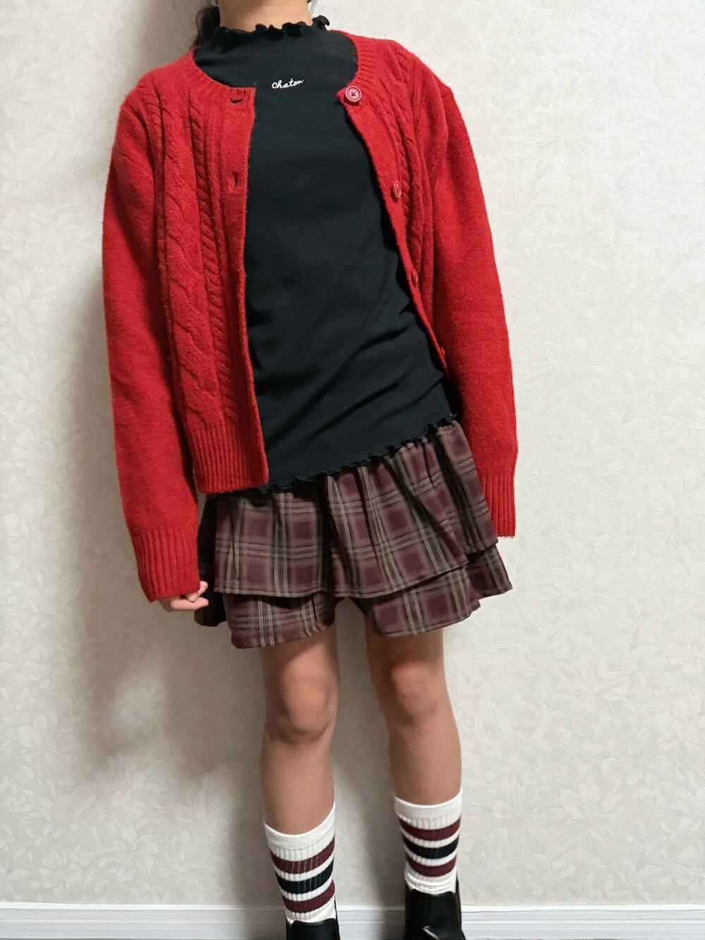 ブラウン系のスカート、ブラック系のブーツ、ブラック系のTシャツ/カットソーを着用したキッズの秋コーディネートの5枚目の写真