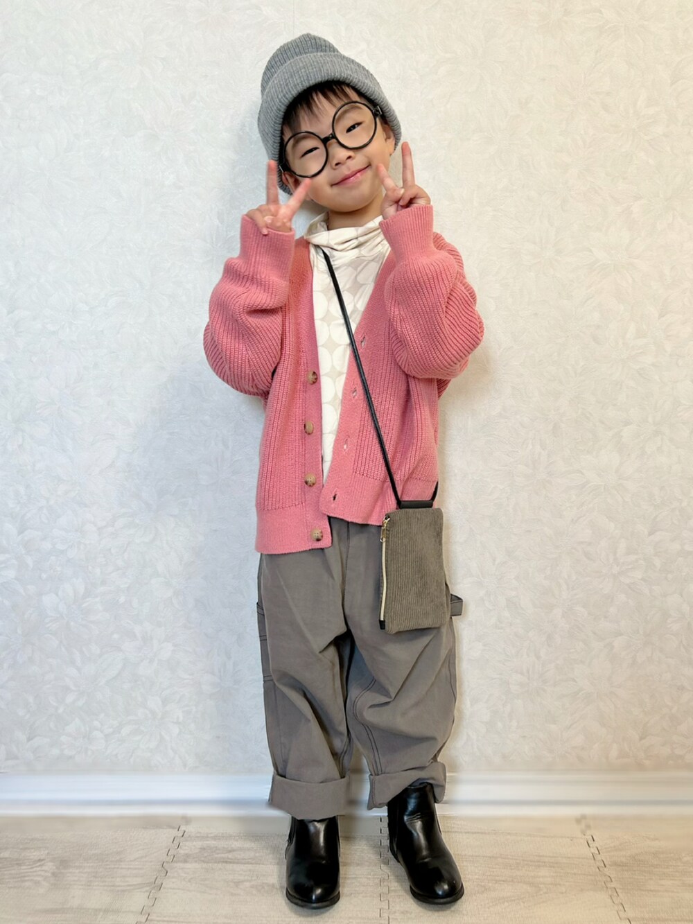 グレー系のTシャツ/カットソー、ピンク系のカーディガン/ボレロ、グレー系のカーゴパンツを着用したキッズの秋コーディネートの3枚目の写真