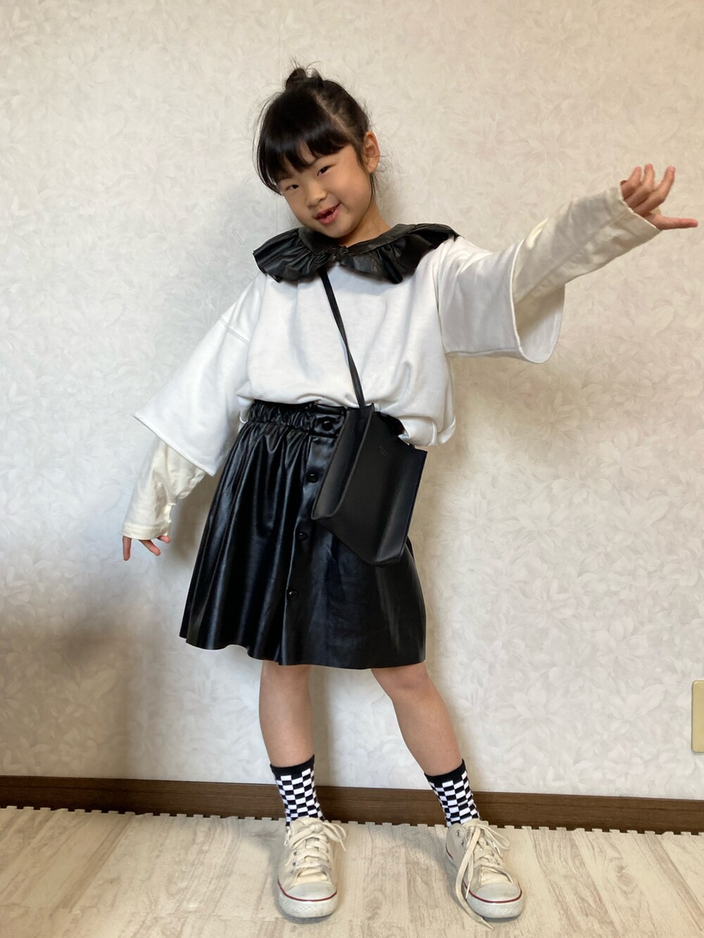 ホワイト系のTシャツ/カットソー、ホワイト系のスウェット、ブラック系のスカートを着用したキッズの冬コーディネートの3枚目の写真