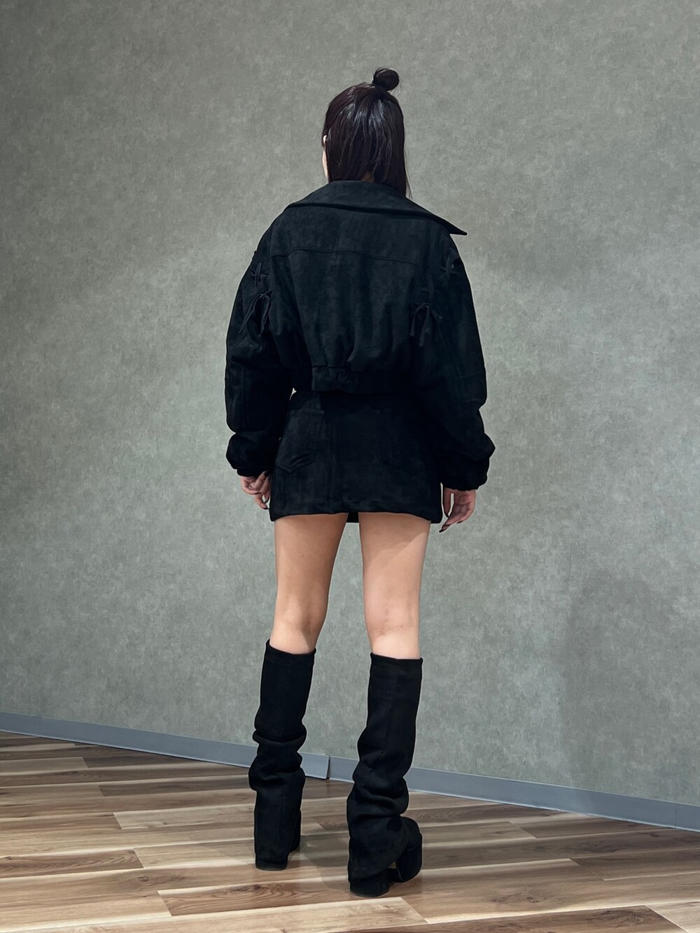 ブラック系のブルゾン、ブラック系のスカート、ホワイト系のTシャツ/カットソーを着用したレディースの秋コーディネートの3枚目の写真