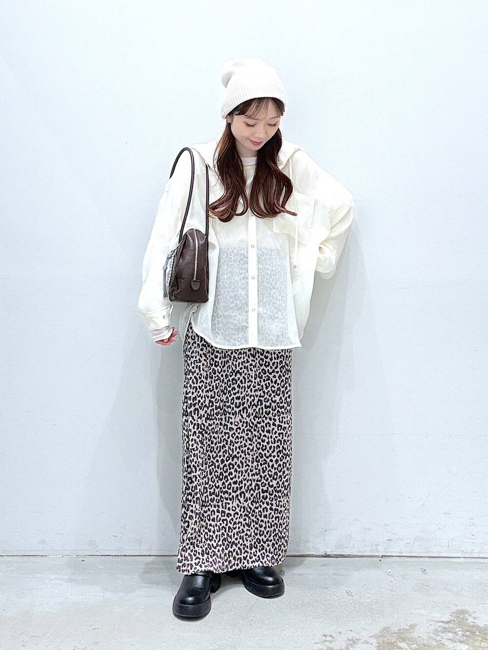 ブラック系のサンダル、ホワイト系のTシャツ/カットソー、ブラウン系のボストンバッグを着用したレディースの春コーディネートの3枚目の写真