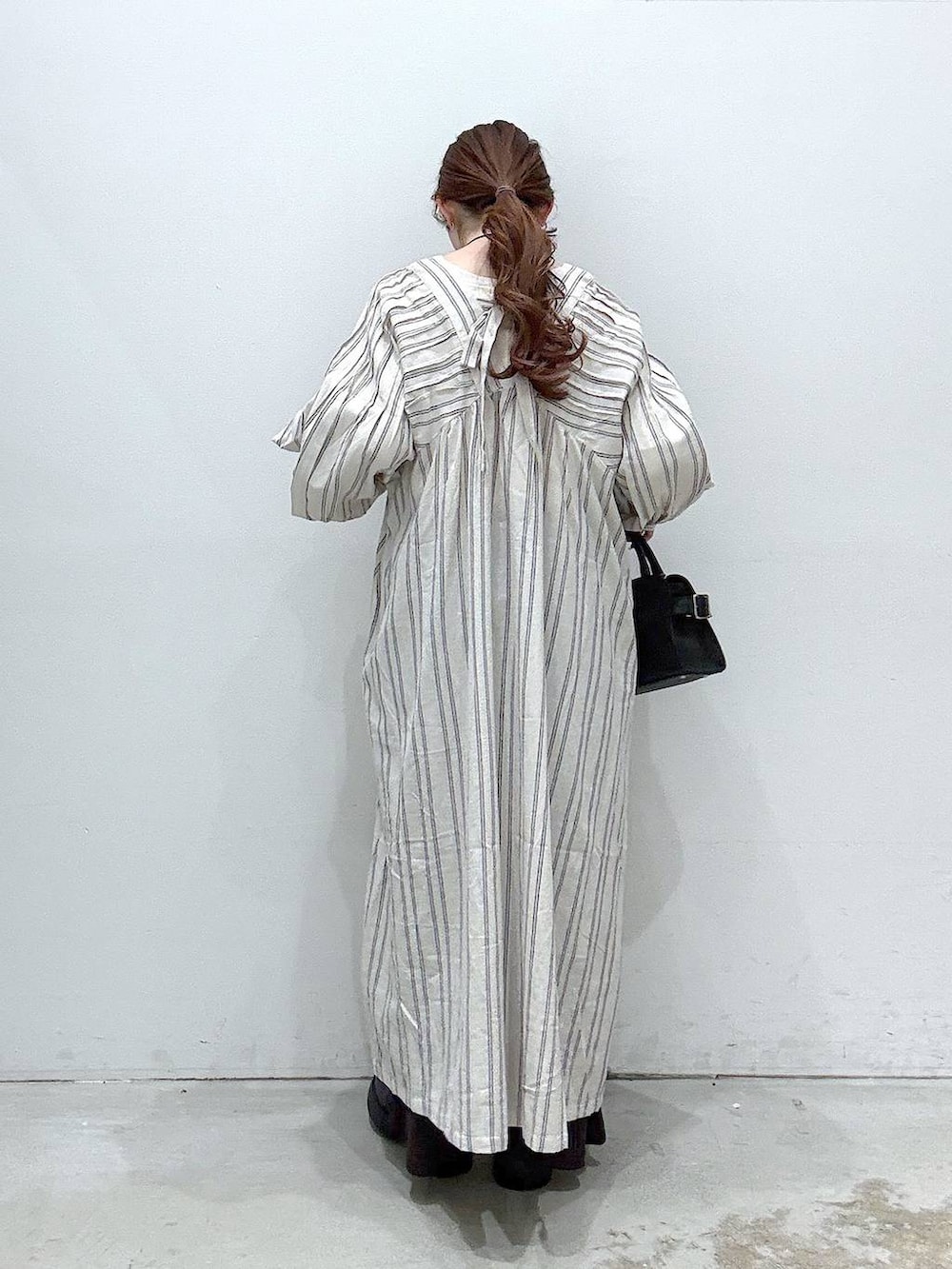 ブラック系のサンダル、ホワイト系のTシャツ/カットソー、ブラック系のショルダーバッグを着用したレディースの春コーディネートの3枚目の写真